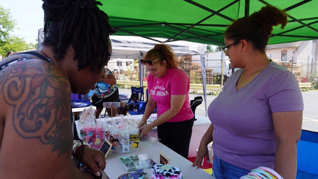 Local vendor displaying decorated cups at the event