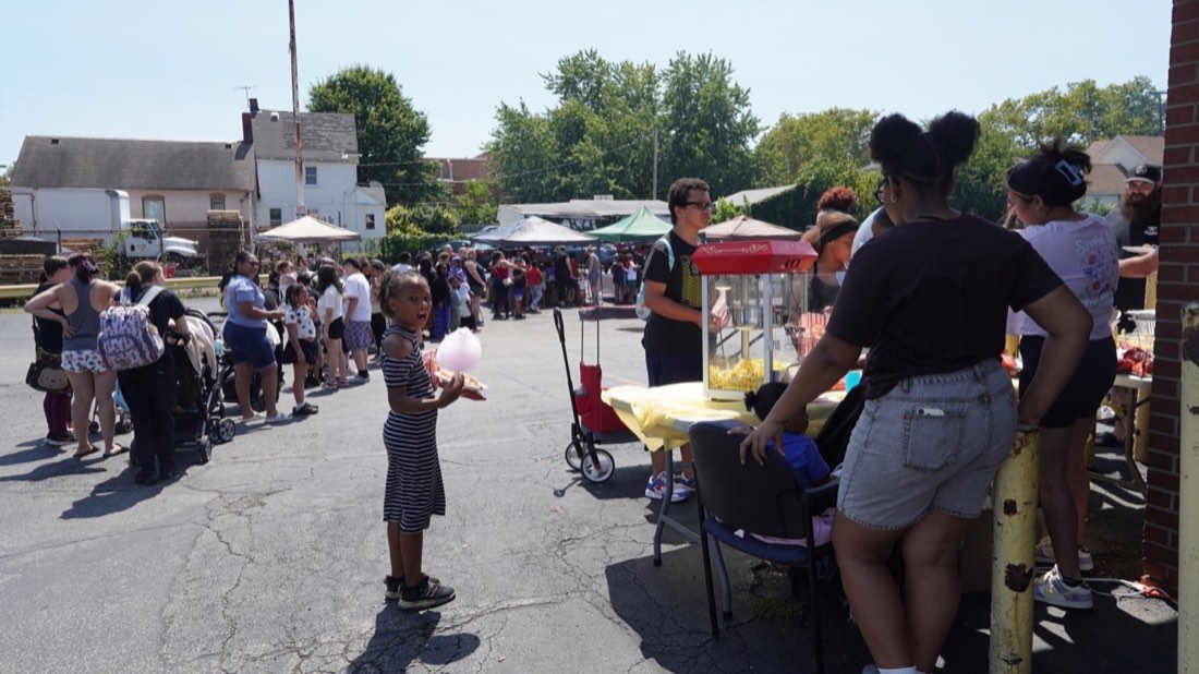 Children and families near the food and activity stations
