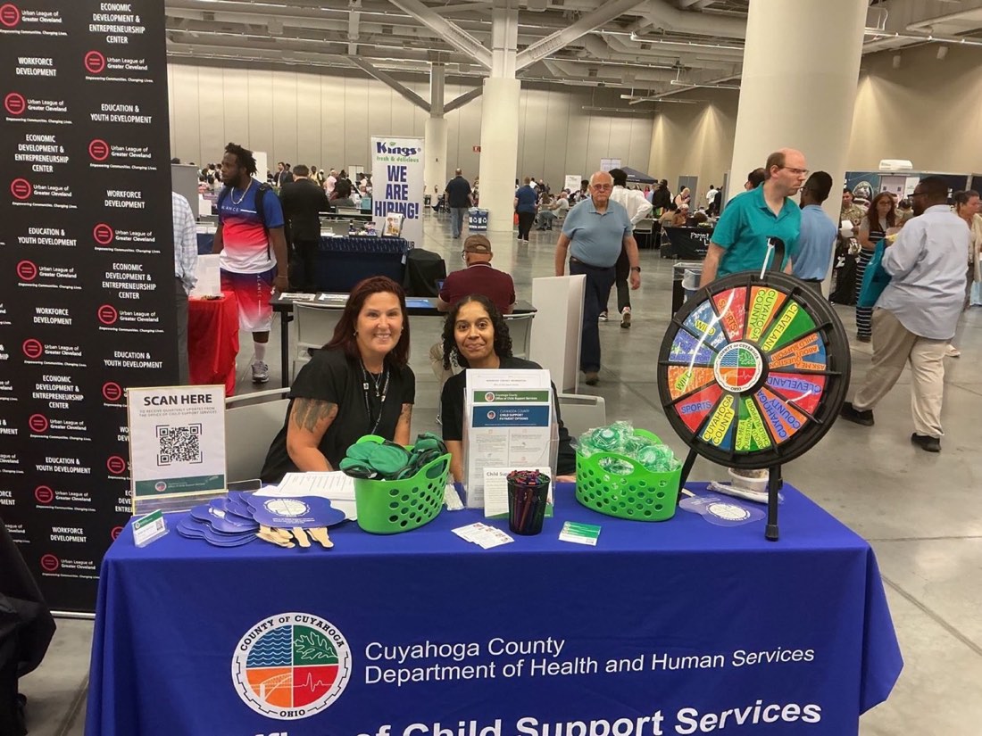 Cuyahoga County child support representatives welcome visitors at the Success Fair.