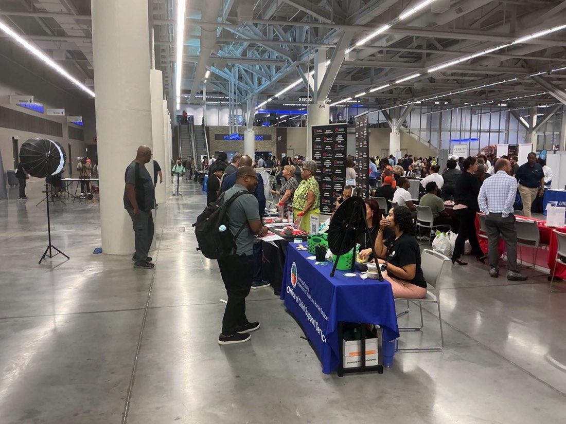 Job seekers speak with exhibitors inside the Huntington Convention Center.