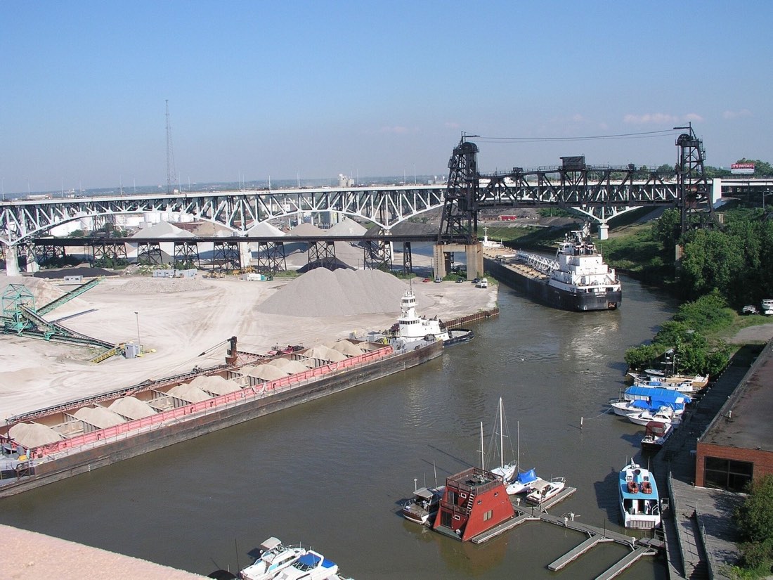 A freighter navigating a bend in the Cuyahoga River near downtown Cleveland