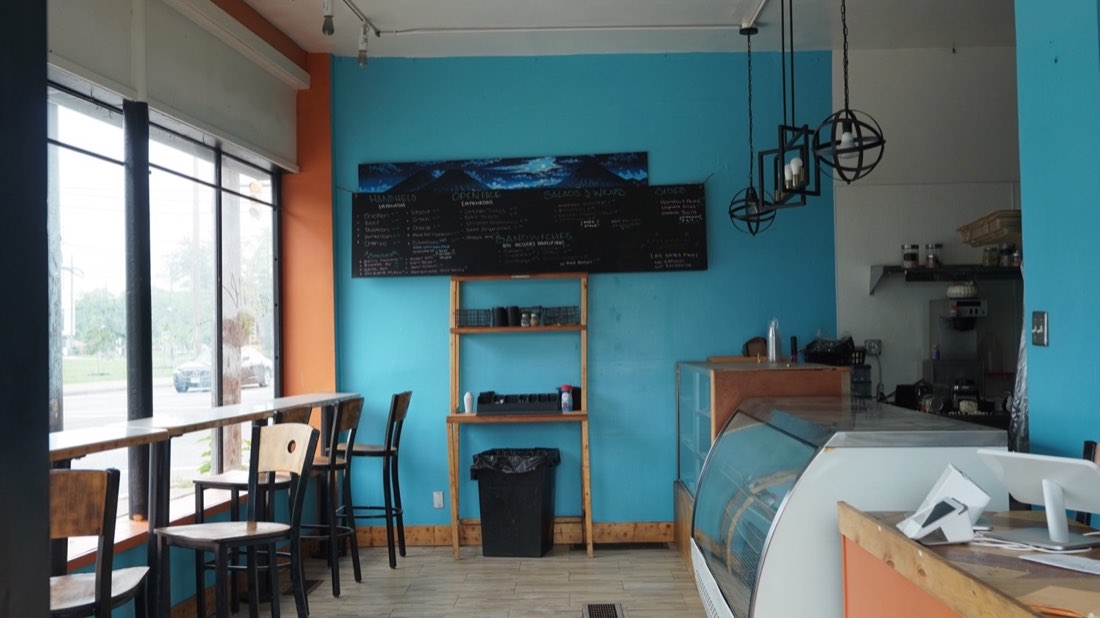 Turquoise dining room and menu inside Half Moon Bakery