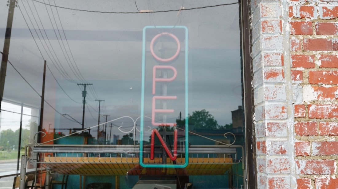 Neon open sign in the Half Moon Bakery window