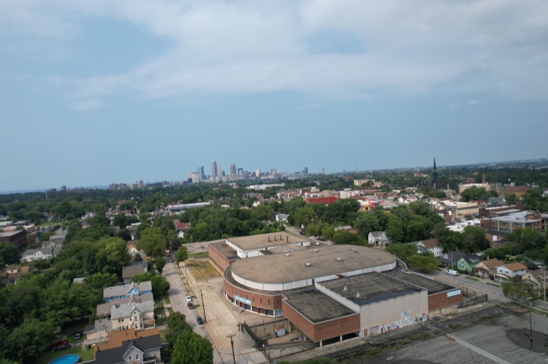 Wide aerial photograph of Lincoln-West High School with the Cleveland skyline and Clark-Fulton neighborhood