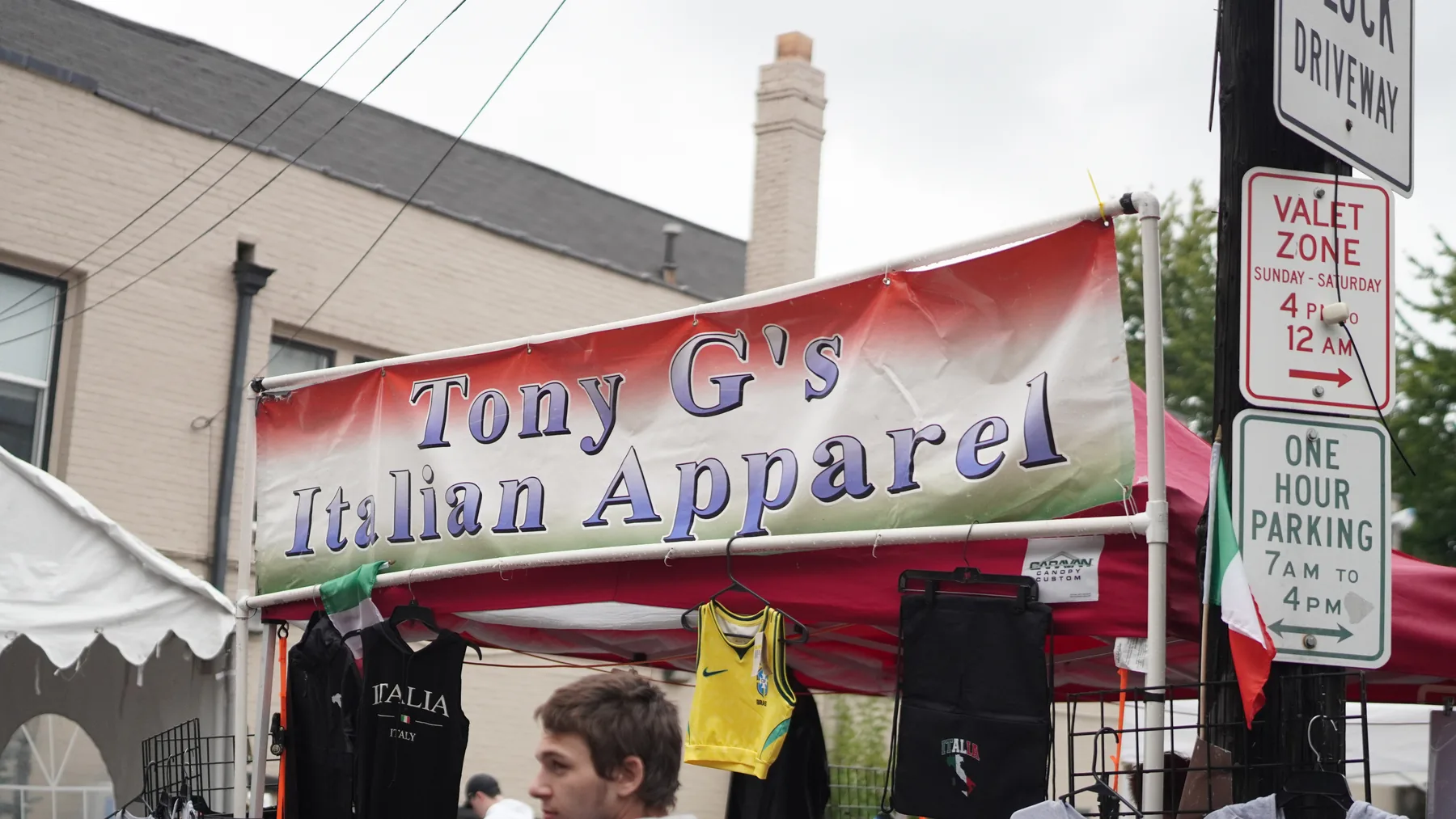 Tony G’s Italian Apparel tent displays Italian-themed clothing.