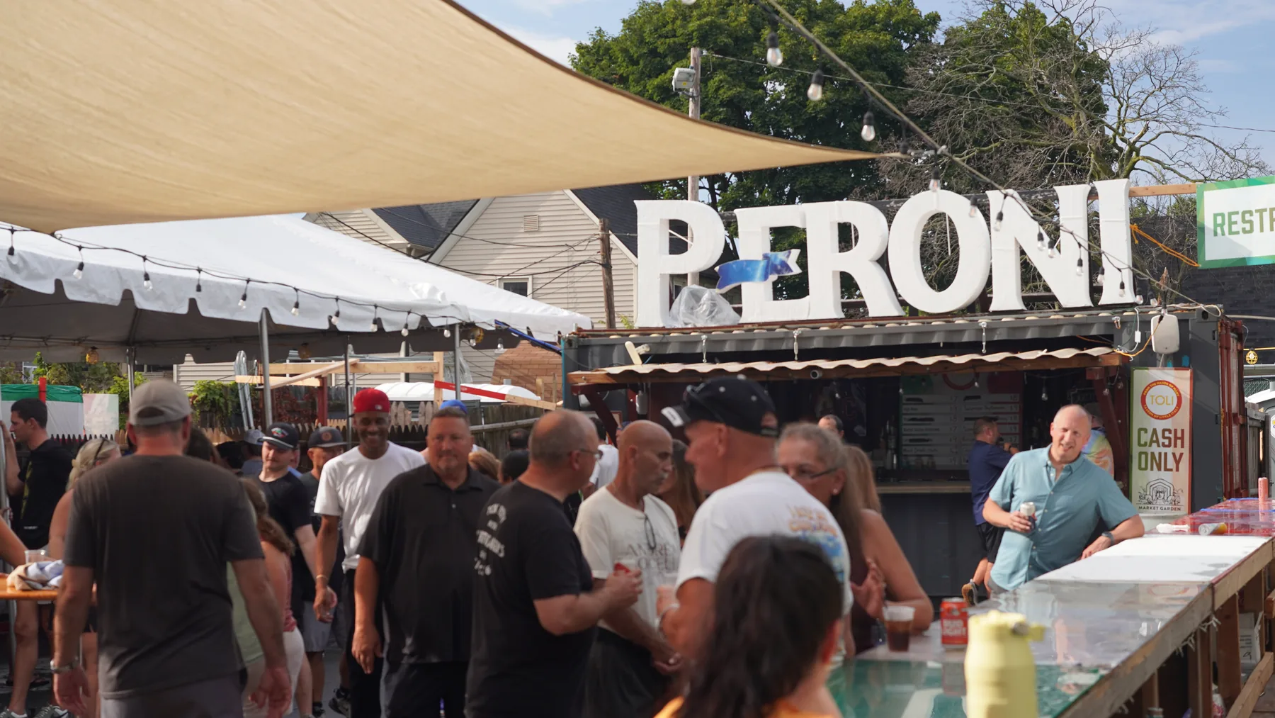 Festival guests gather near a PERONI refreshment tent.