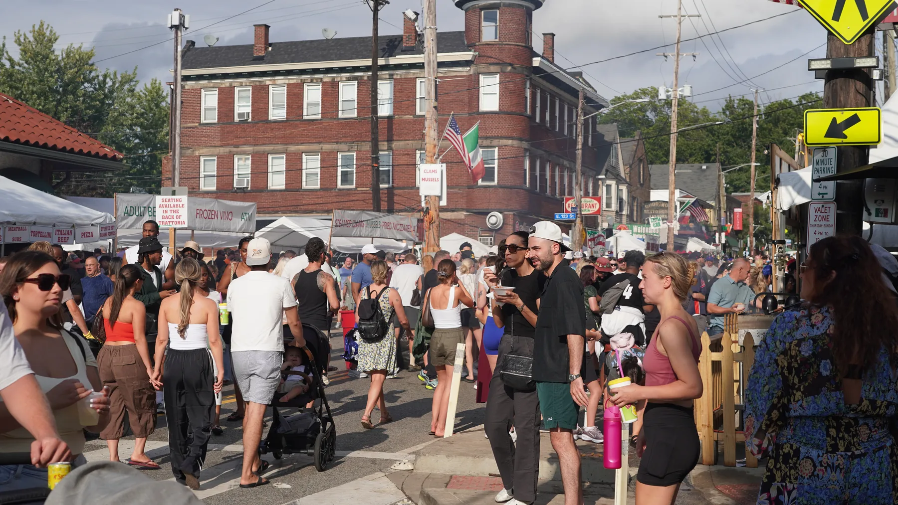 Sunshine fills a crowded Little Italy street after clouds threatened the festival.