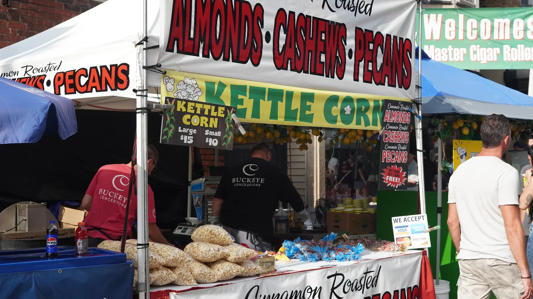 A vendor sells kettle corn and cinnamon-roasted nuts.