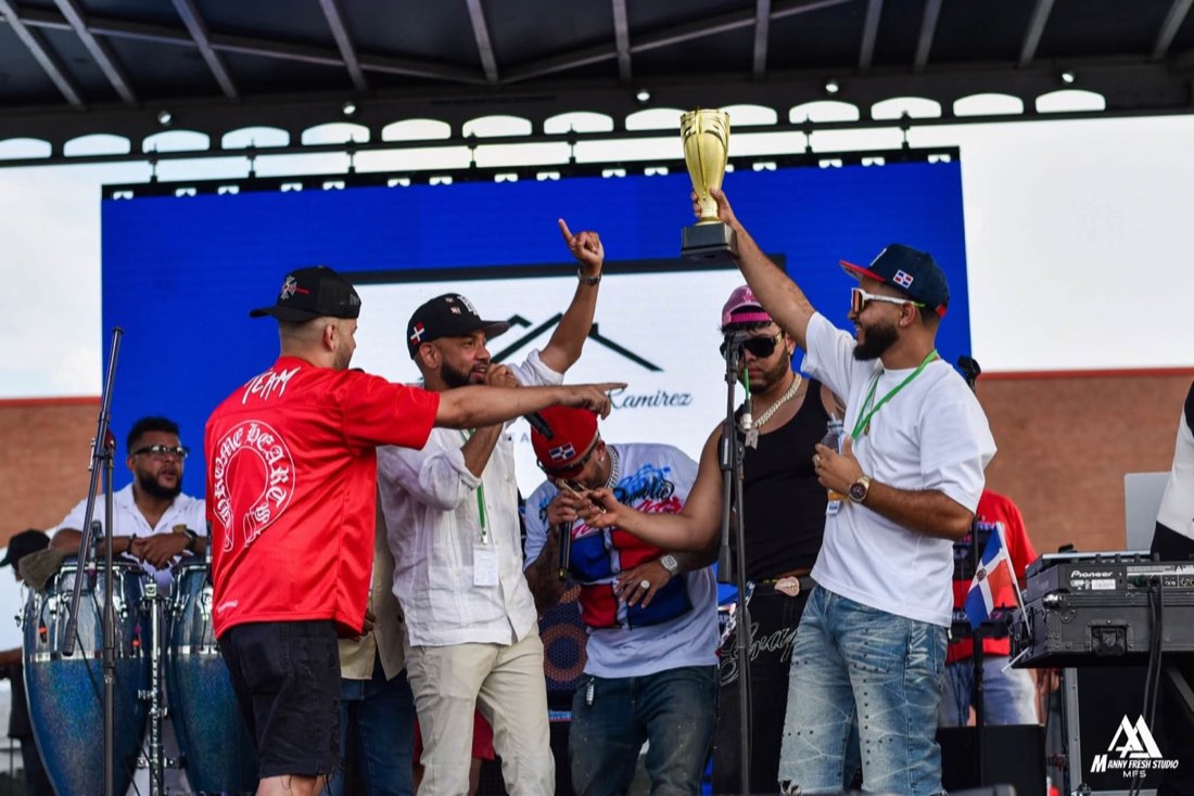 Festival organizers holding a trophy onstage