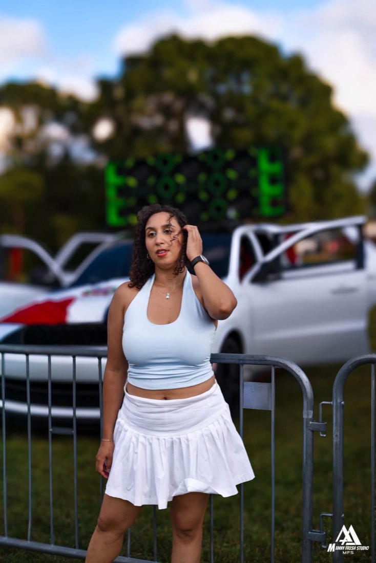 Festival attendee near a sound-system vehicle