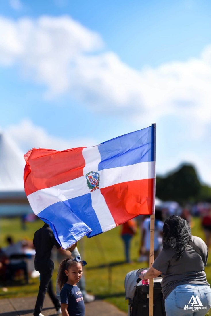 Dominican flag waving above festivalgoers