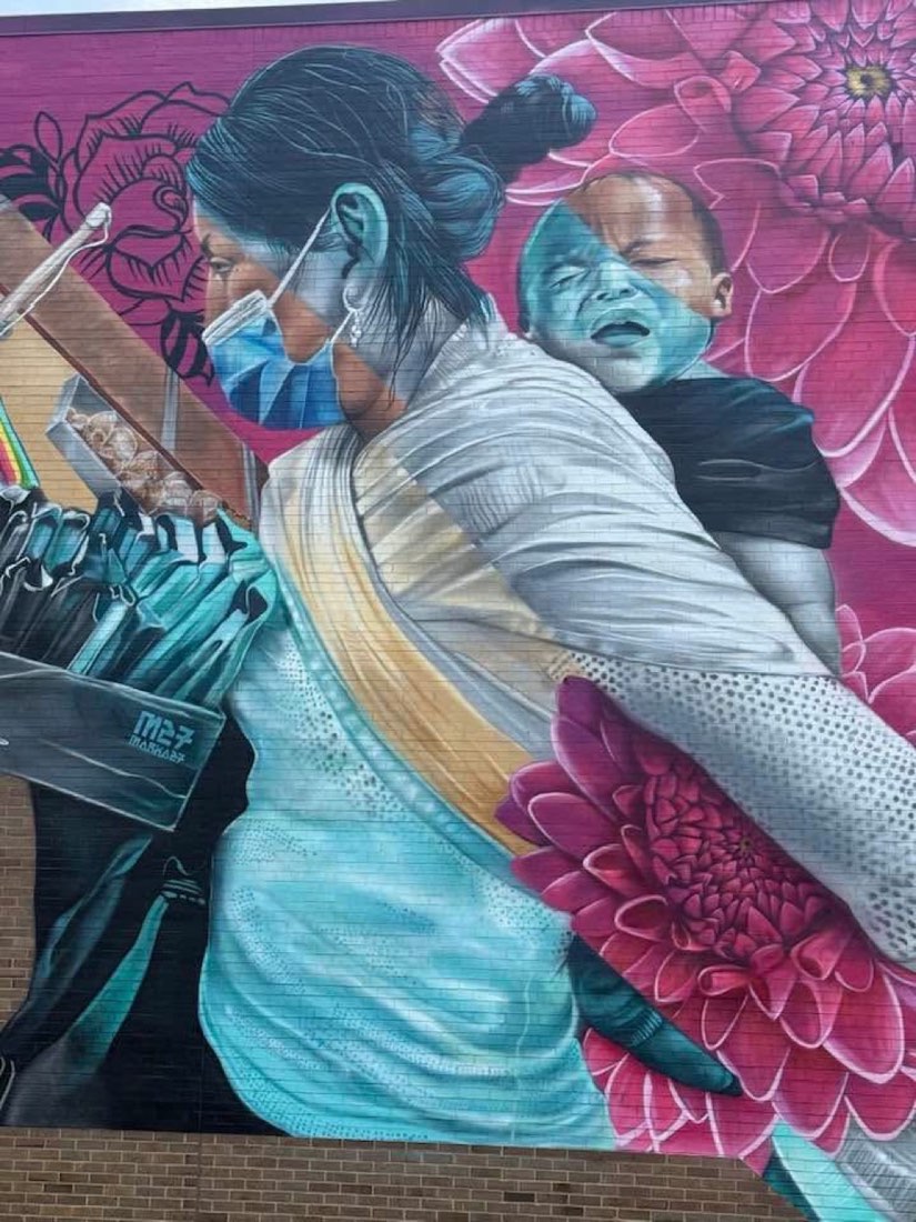 Detail of a mother carrying a child in the MARKA27 Eastman Branch mural