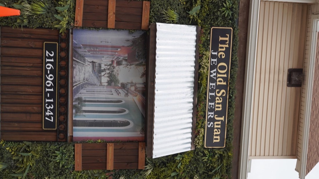 Old San Juan Jewelers sign above an image of an Old San Juan street