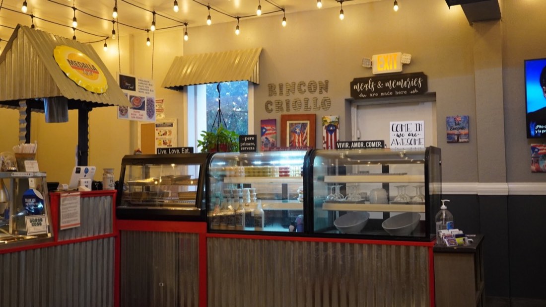 Service counter and display cases at Rincón Criollo