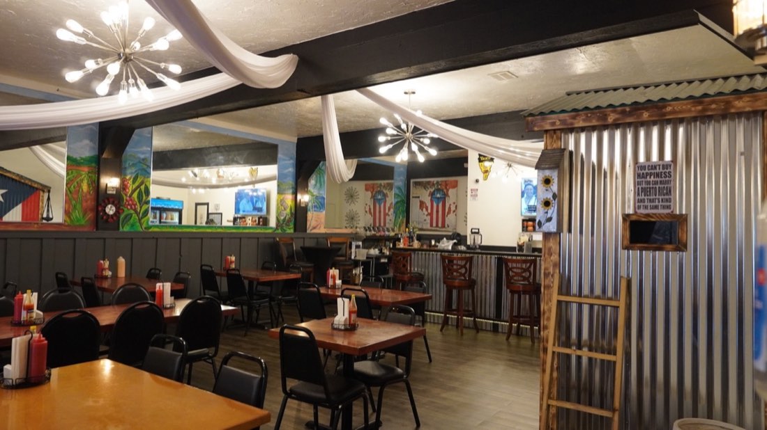 Dining room at Rincón Criollo with Puerto Rican artwork