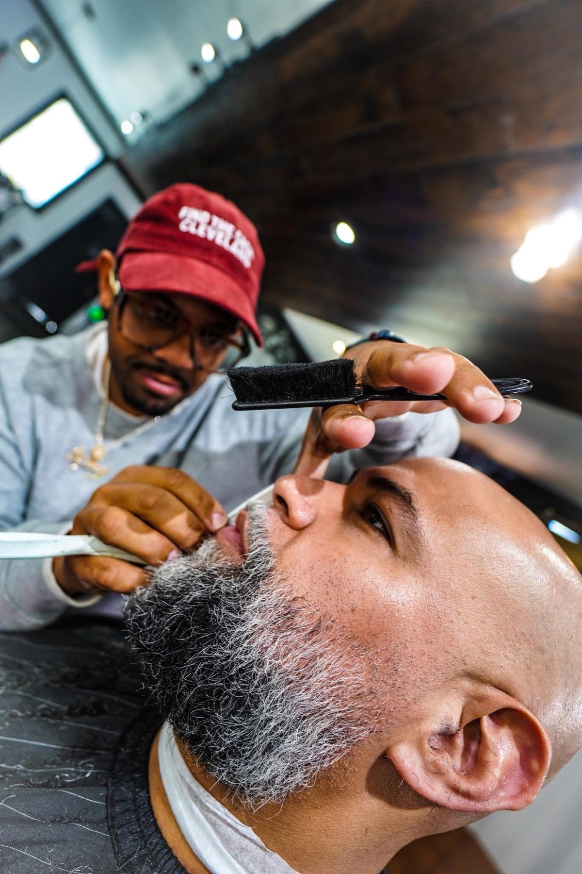 Khristian Santana shaping a client's beard at Supremacy Barbershop