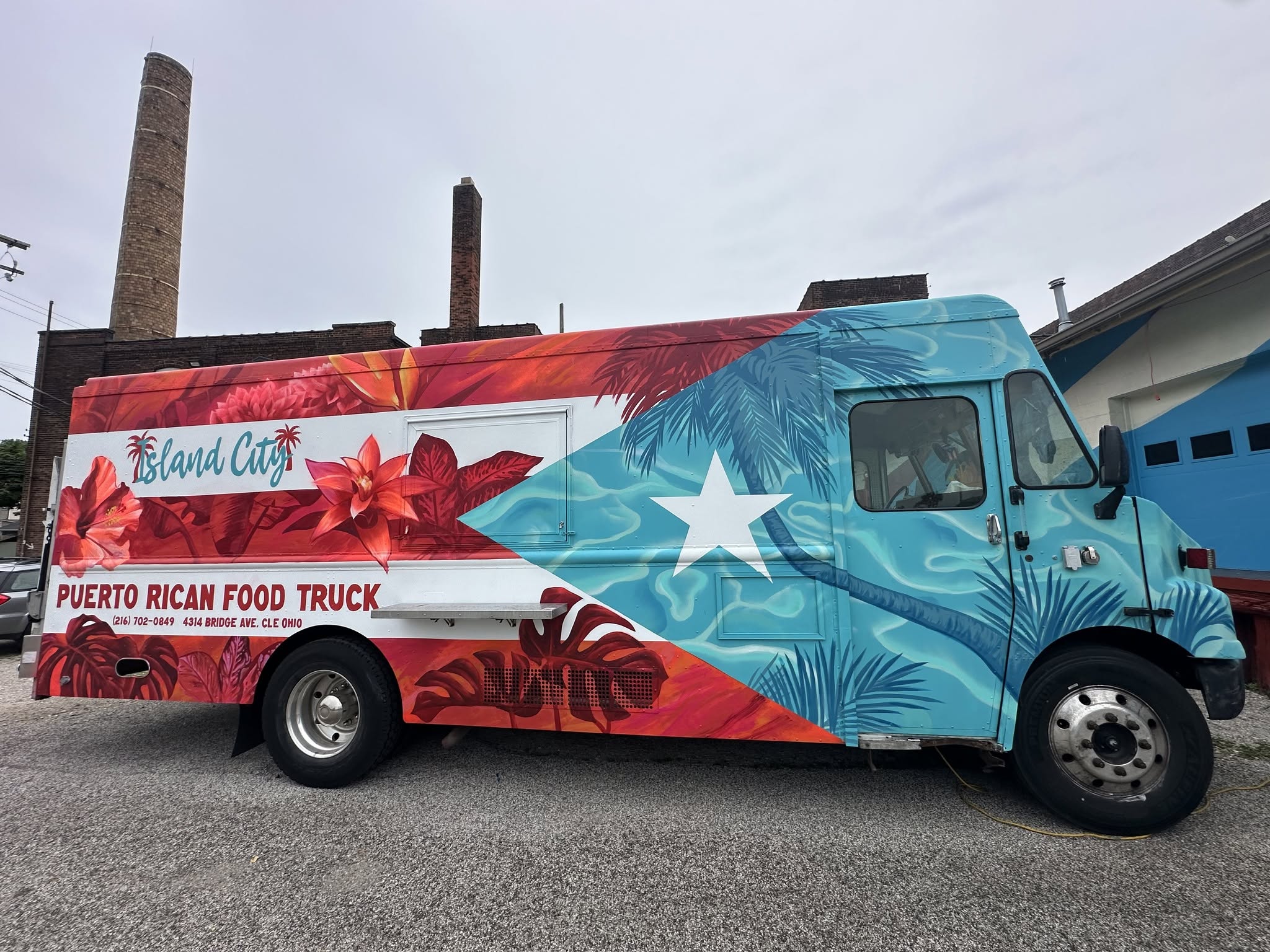 Island City Puerto Rican Food Truck decorated with tropical flowers and the Puerto Rican flag.