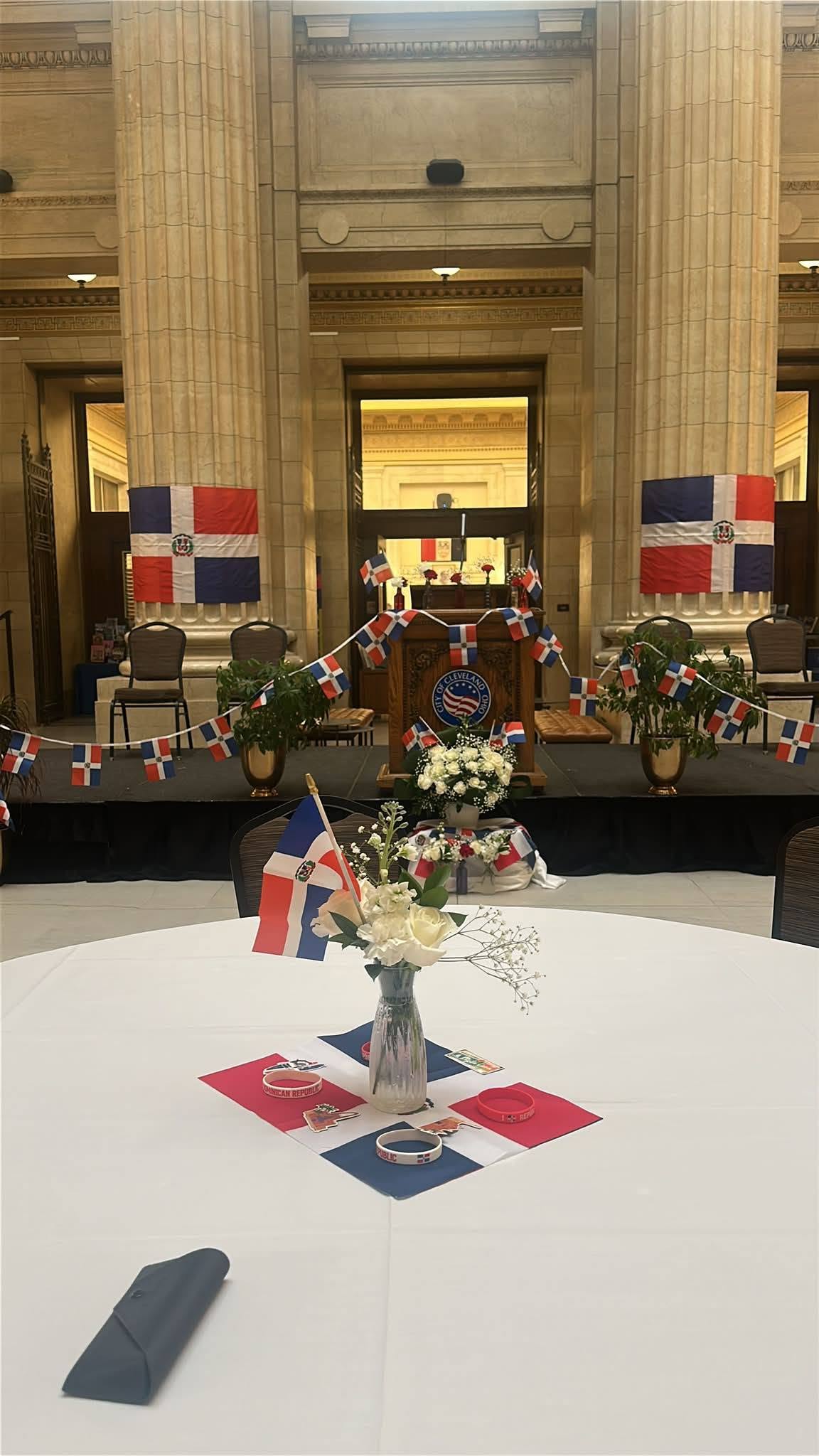 Cleveland City Hall rotunda decorated with Dominican Republic flags for the Club Dominicano de Cleveland ceremony.