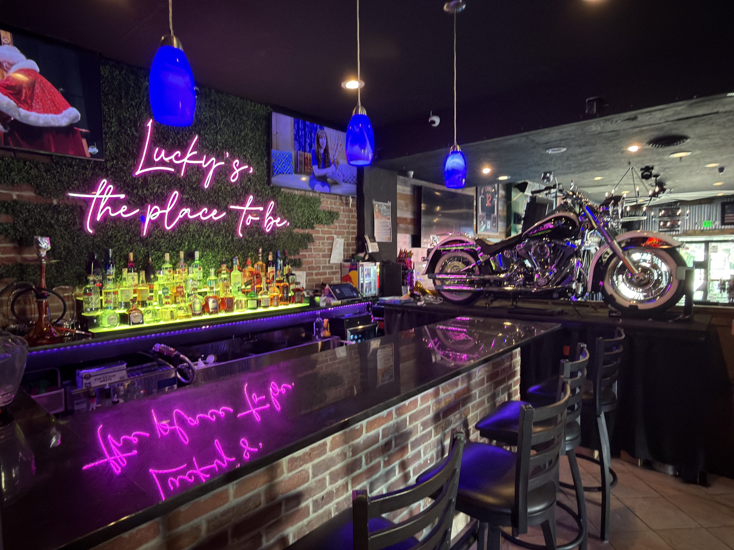 Neon-lit bar and motorcycle display inside Lucky’s