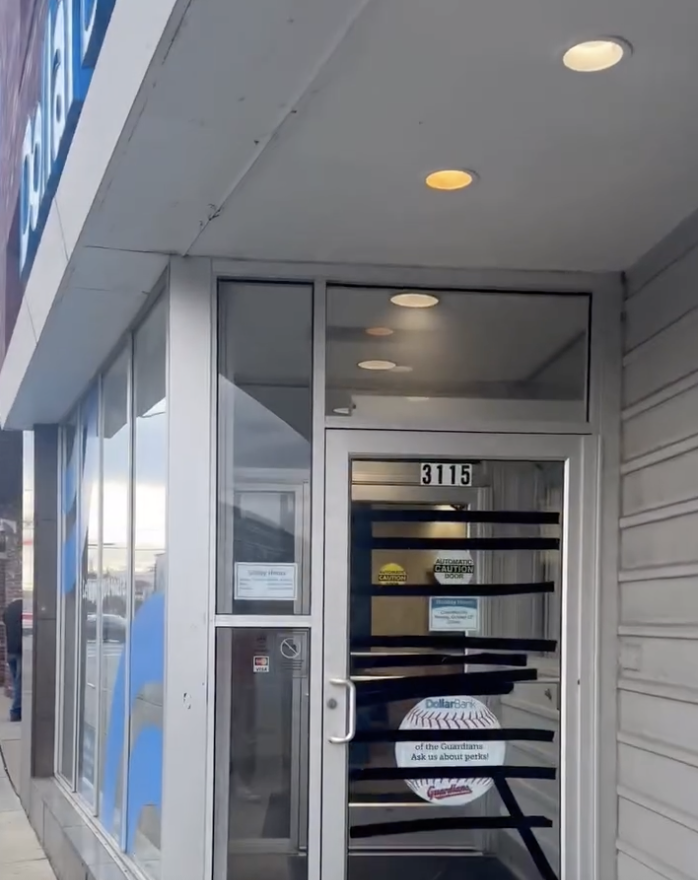 Dollar Bank entrance marked 3115 with black tape across the glass