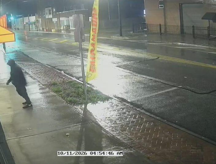 Exterior surveillance view showing a person near the storefront