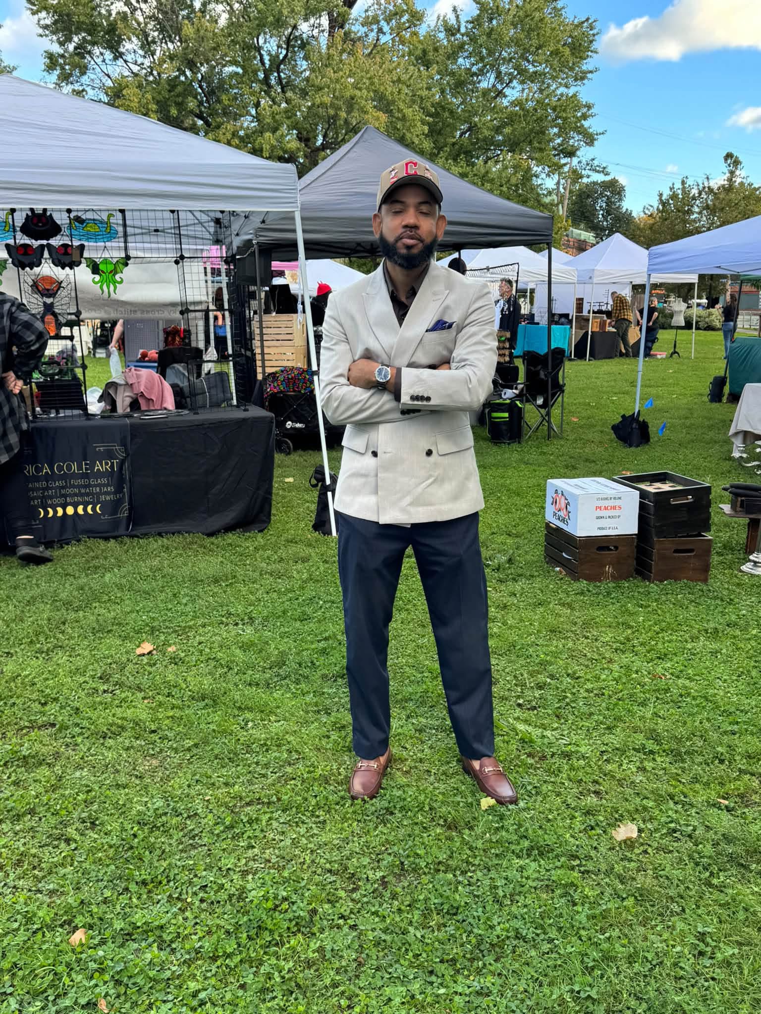 A person standing among tents at an outdoor market