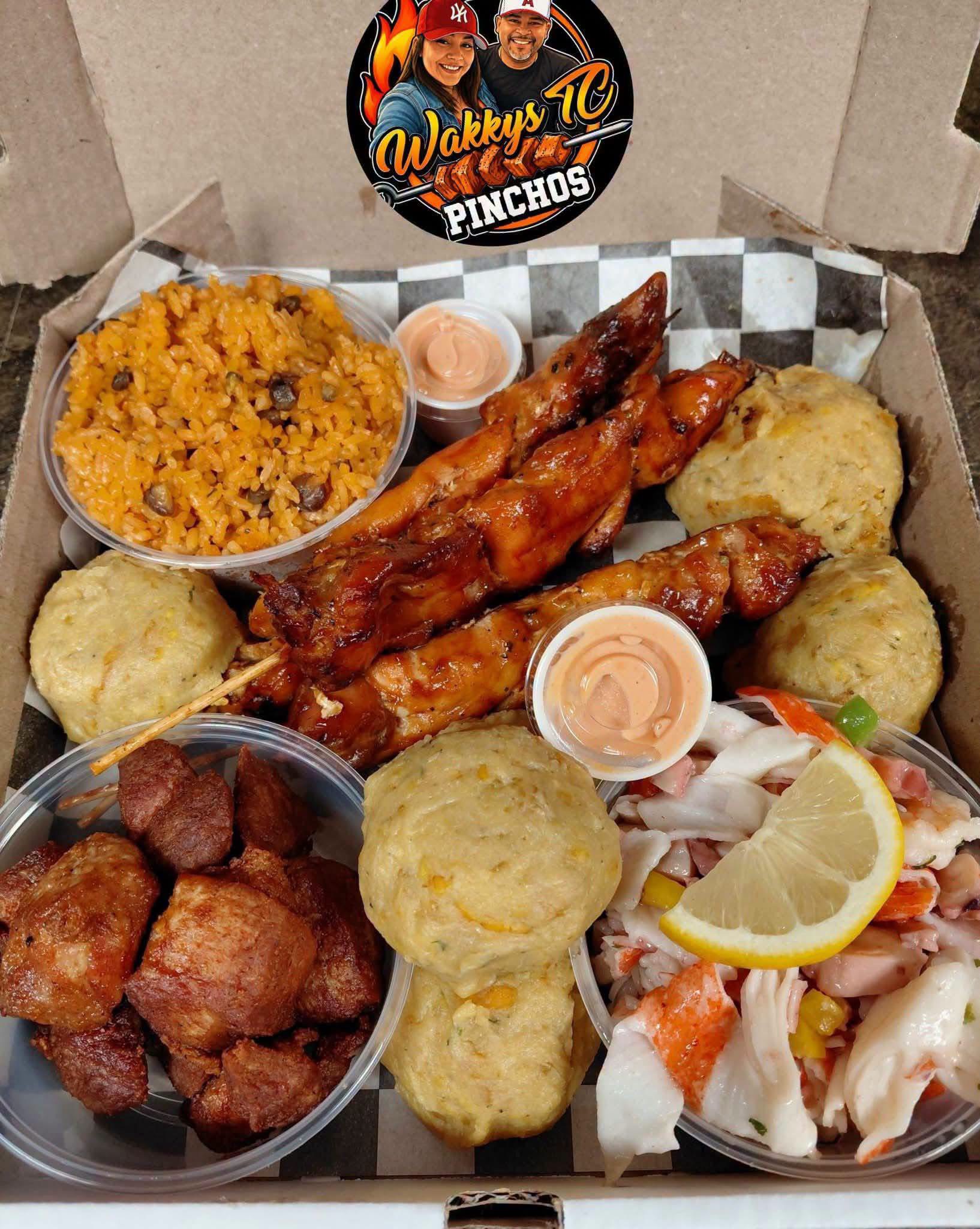 Wakky’s TC Pinchos full food box with grilled skewers, rice, sides, and sauces.