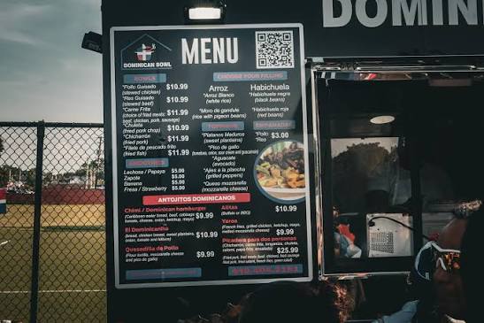 The posted menu beside the Dominican Bowl truck service window