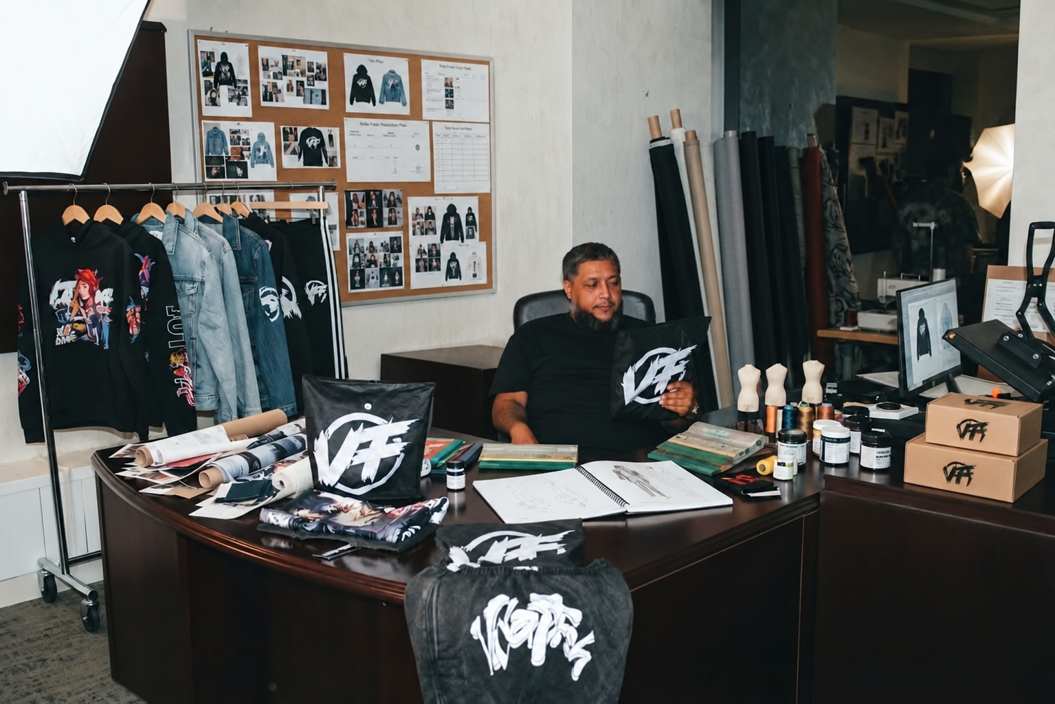 Edited VIDA FRESH promotional image of a seated man holding a VF-branded item at a desk